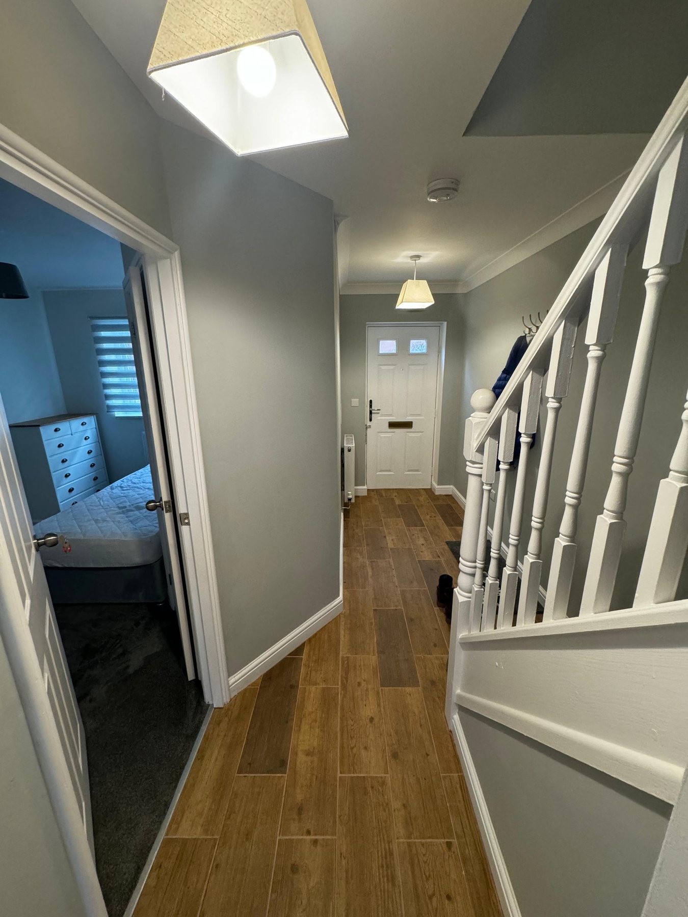 Finished hallway with staircase and wood effect flooring