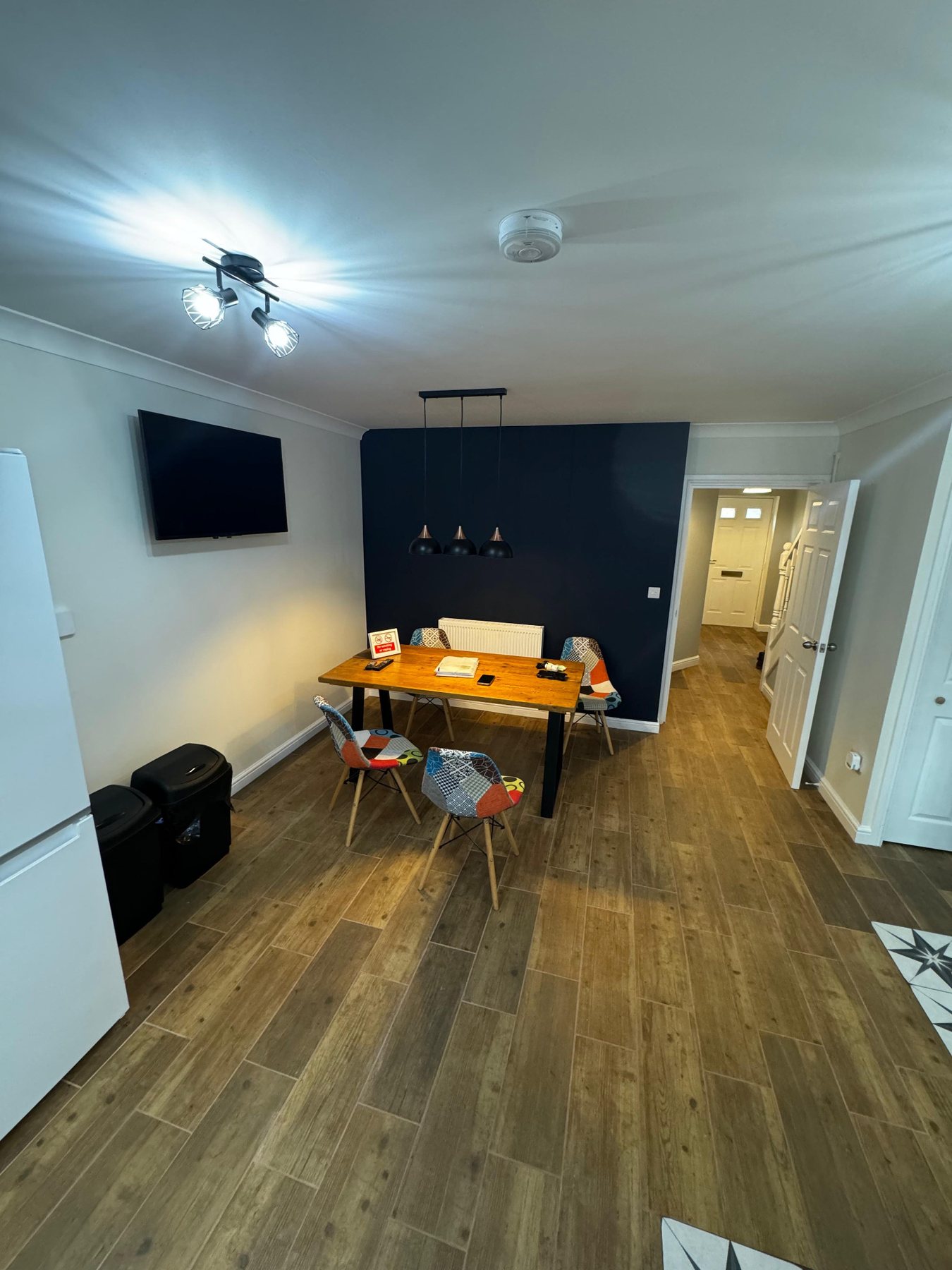Shared living and dining area with wall mounted TV