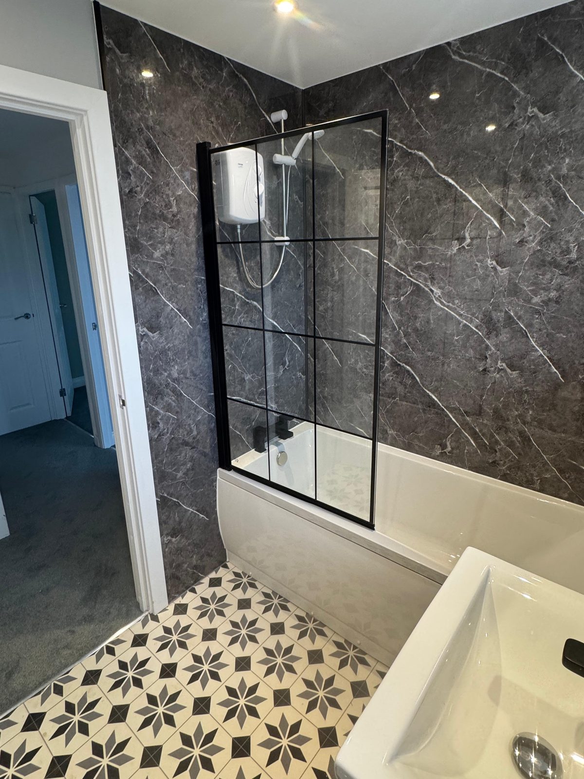 Bathroom with shower screen and wall panels